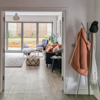 Wooden LVT flooring in a bathroom with an elegant stainless steel bath tub